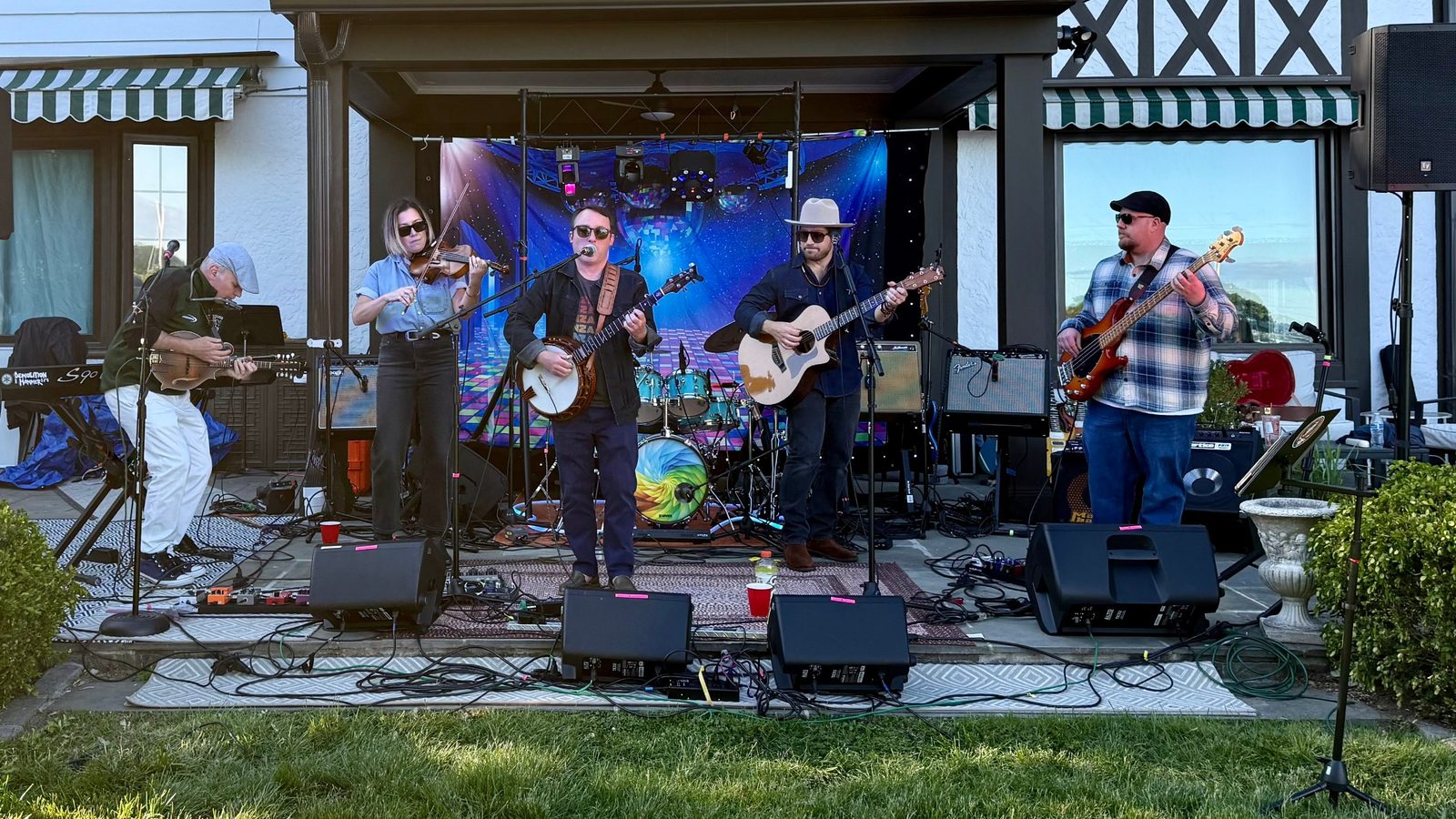 Heart Fjord playing a backyard patio stage at golden hour